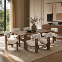 A dining room set featuring a rectangular dark wood table and six matching armchairs with cream upholstered seats and backs, styled in a modern, sunlit dining room.