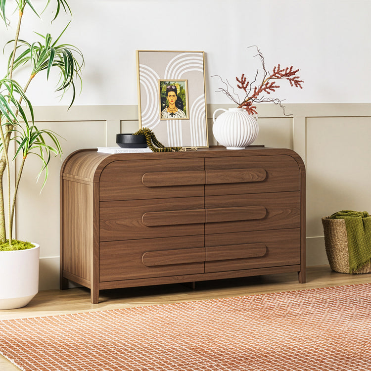 Wooden dresser with decorative items in a room setting