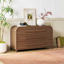 Wooden dresser with decorative items in a room setting