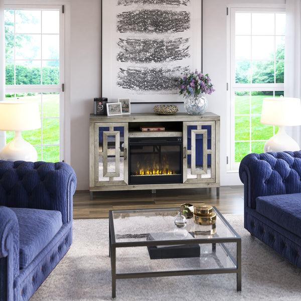 Living room with blue sofas, a glass coffee table, and a decorative fireplace.