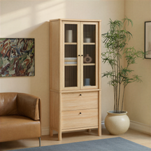 Wooden cabinet with glass doors in a room with a brown sofa and a plant.