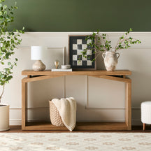 Wooden console table with decorative items in a room with a green wall.